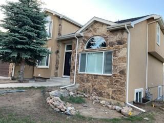 A large house with a tree in front of it.