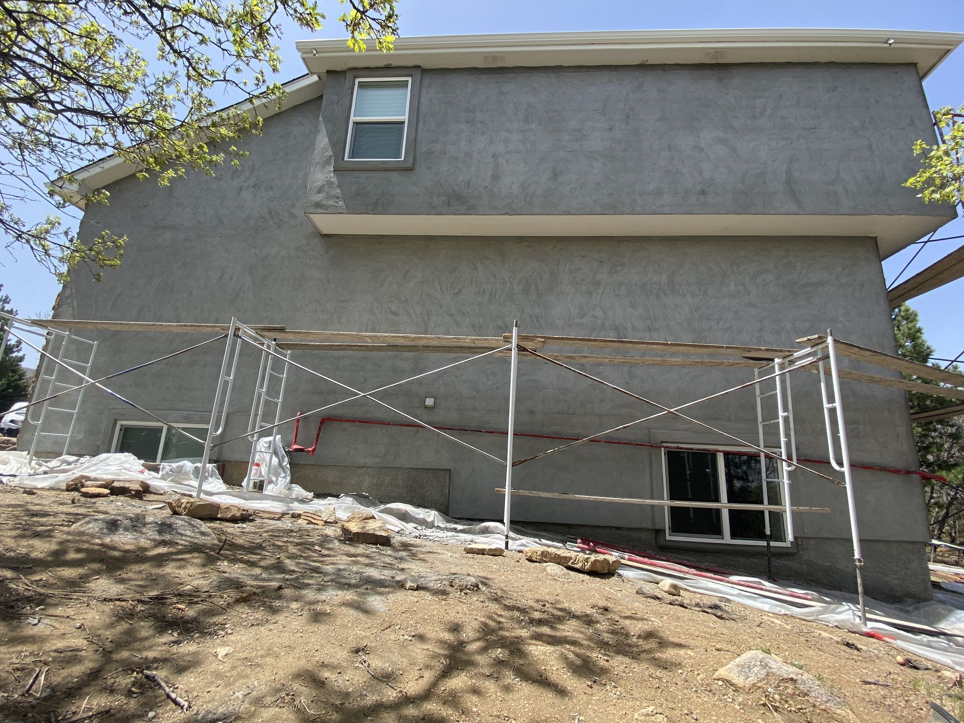 A house with scaffolding around it is being painted.