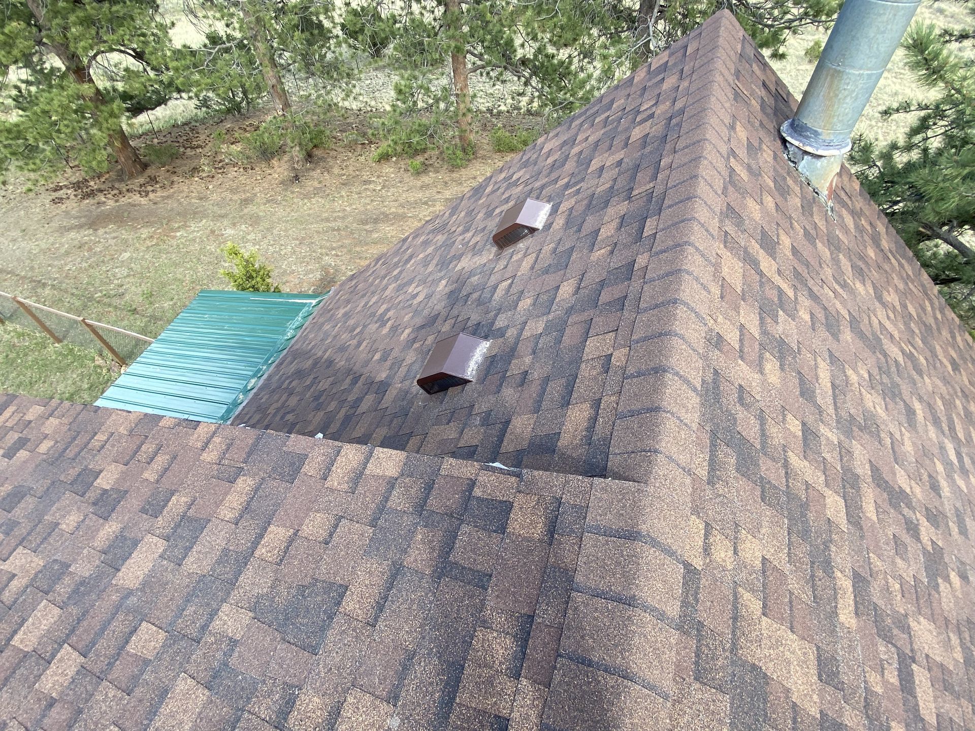 An aerial view of a roof with a chimney on it.
