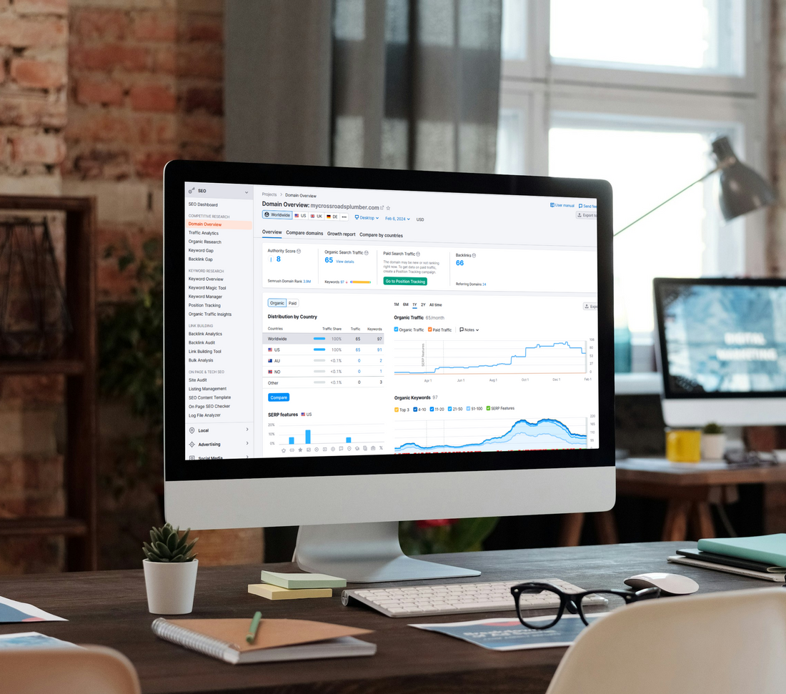 A computer monitor is sitting on a desk in front of a window.