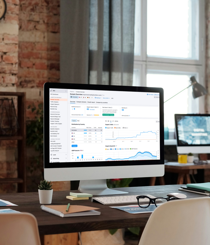 A computer monitor is sitting on a desk in front of a window