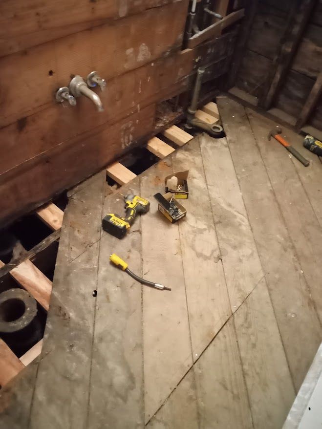 A wooden floor with a bunch of tools on it