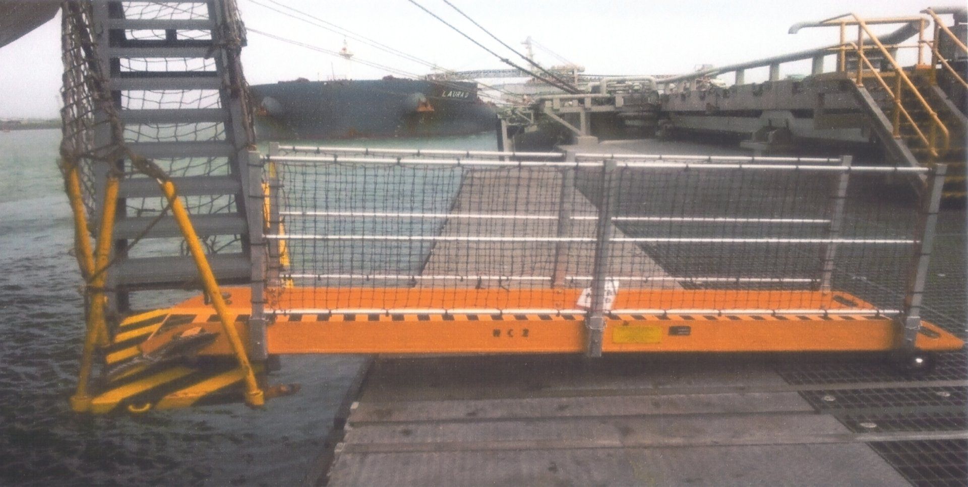 A dock with stairs leading up to a large ship