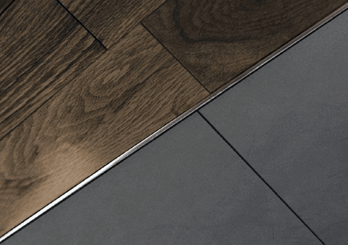 A metal strip transition separates tile from wood floor panels