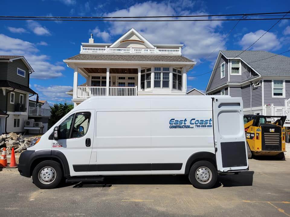 An East Coast Construction van parked in front of a New Jersey shore house job site