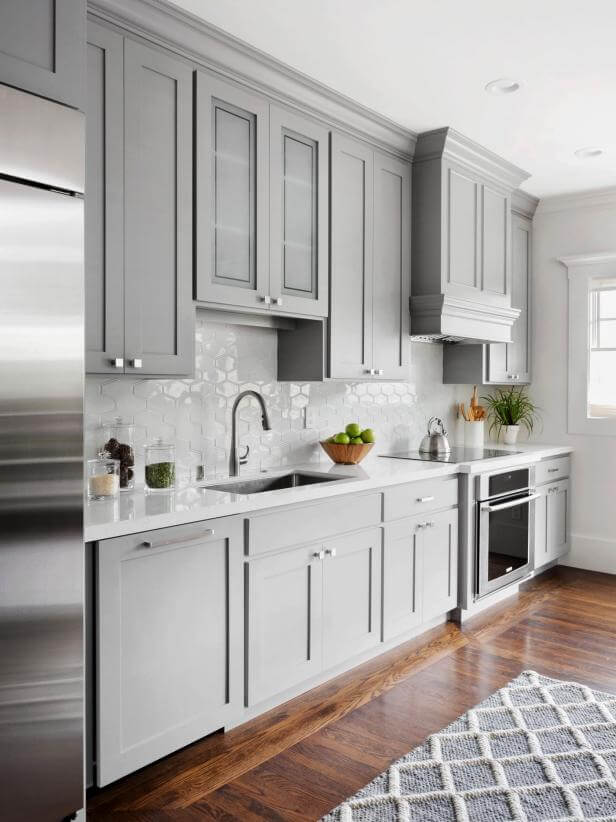 Grey kitchen cabinets with red oak flooring