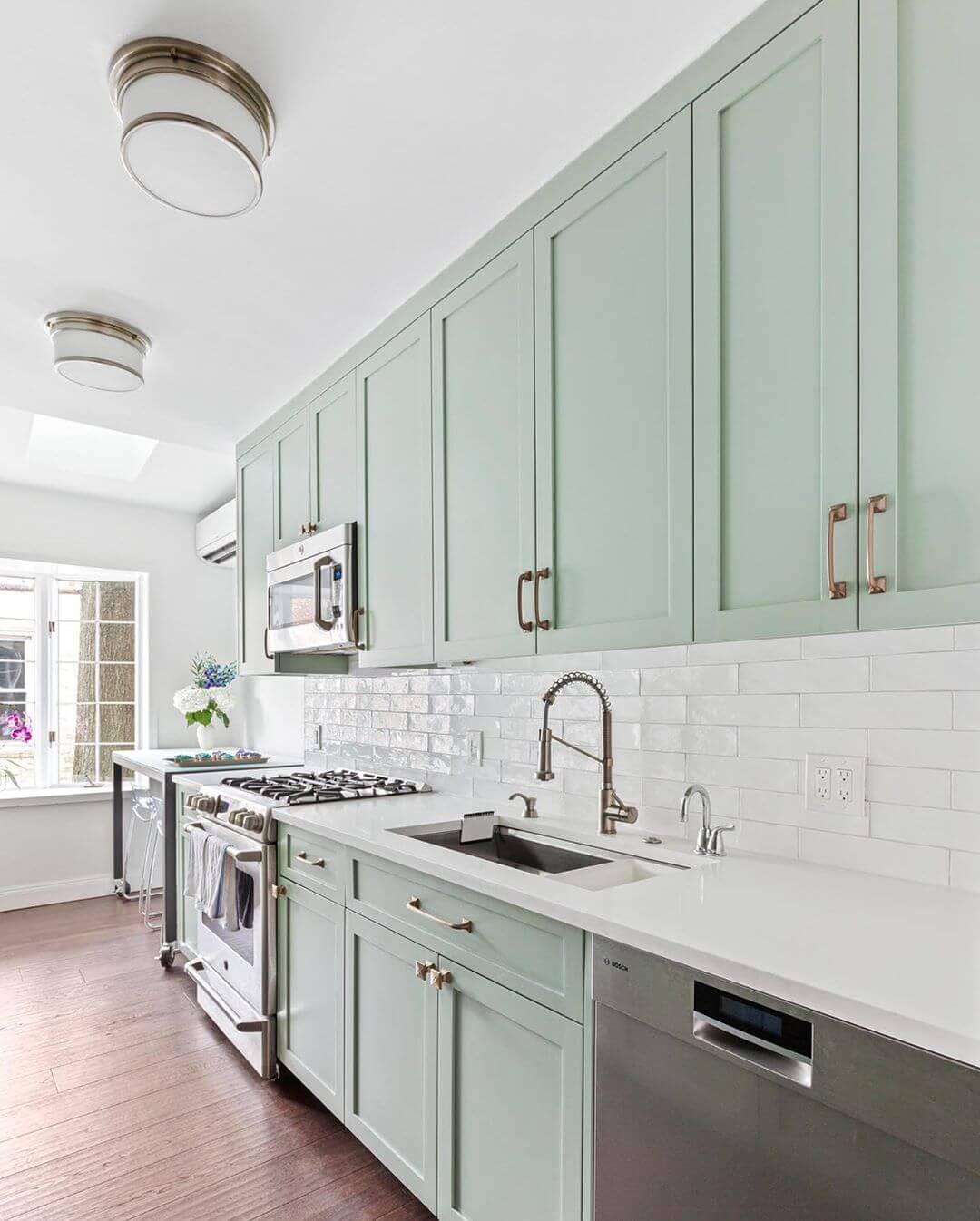 Mint green kitchen cabinets are in this year