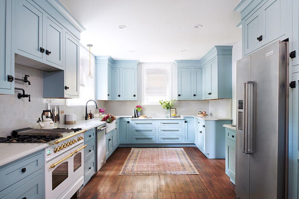Powder blue kitchen cabinets pair well with KitchenAid stainless steel appliances