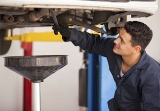 Mechanic Draining Engine Oil
