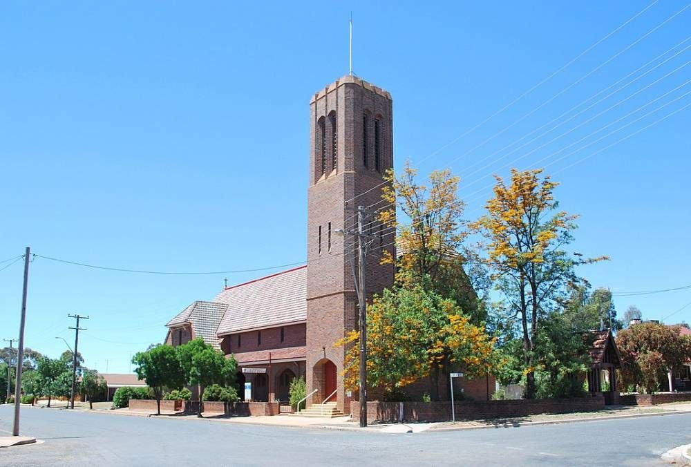 A Large Brick Church With A Steeple In The Middle Of A Street — Blackpoly Pipelines in West Wyalong, NSW