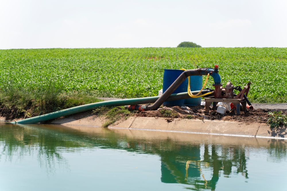 A Hose Is Connected To A Water Pump In A Field — Blackpoly Pipelines in Lithgow, NSW