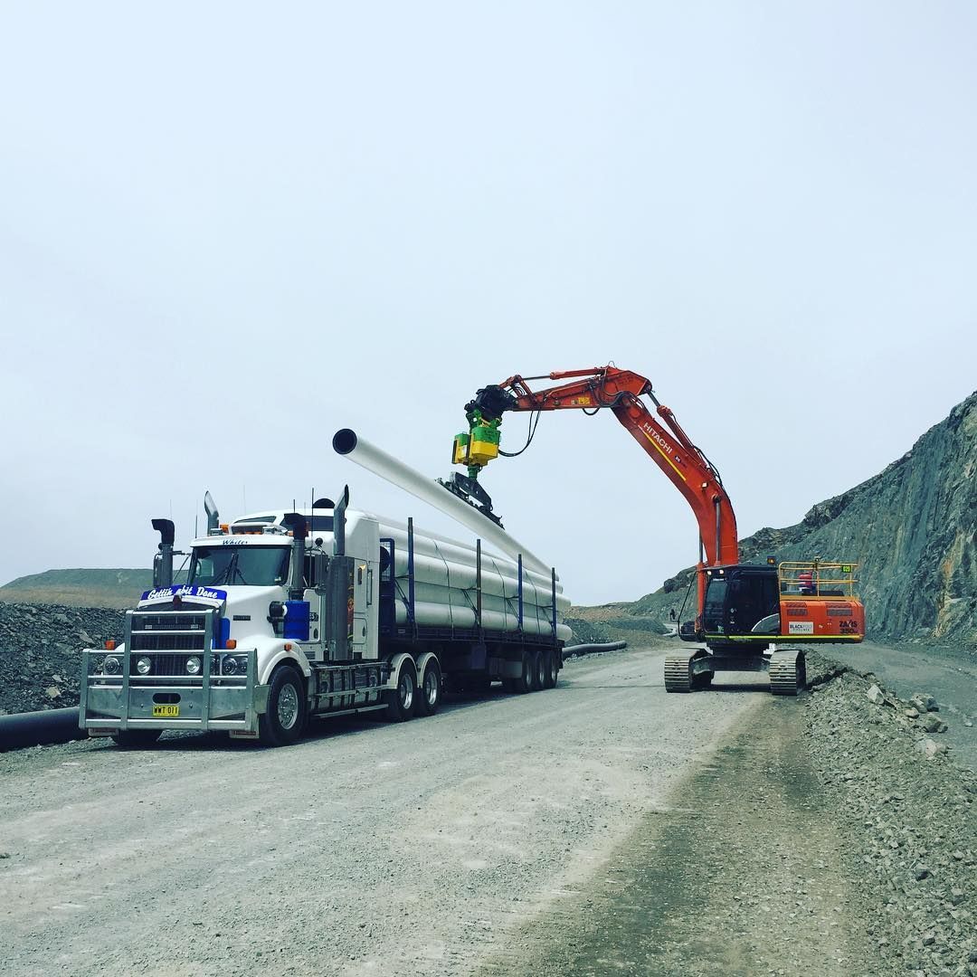 A Truck Is Being Lifted By A Crane On A Dirt Road — Blackpoly Pipelines in Orange, NSW