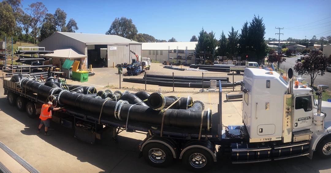 A Large Semi Truck Is Carrying A Large Load Of Pipes — Blackpoly Pipelines in Orange, NSW