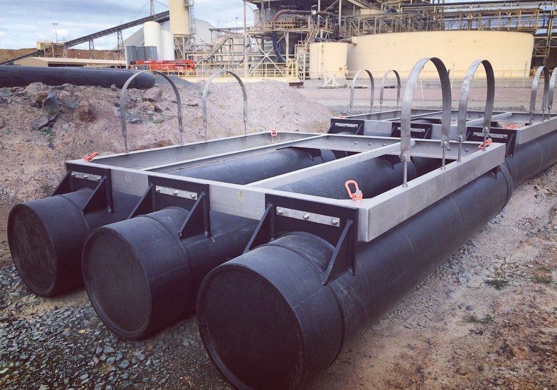 A Bunch Of Black Pipes Are Sitting On Top Of Each Other In A Field — Blackpoly Pipelines in West Wyalong, NSW