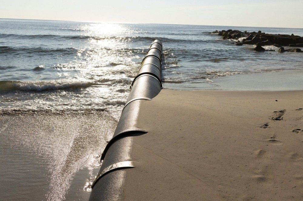 A Pipe Is Going Into The Ocean On A Sandy Beach — Blackpoly Pipelines in Orange, NSW