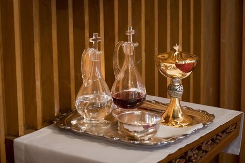 a tray with a chalice and a bottle of wine on it
