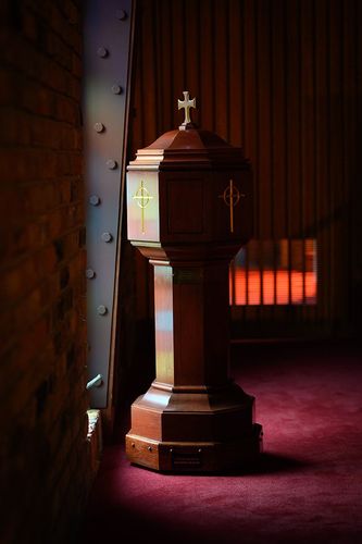 a wooden baptismal font with a cross on top