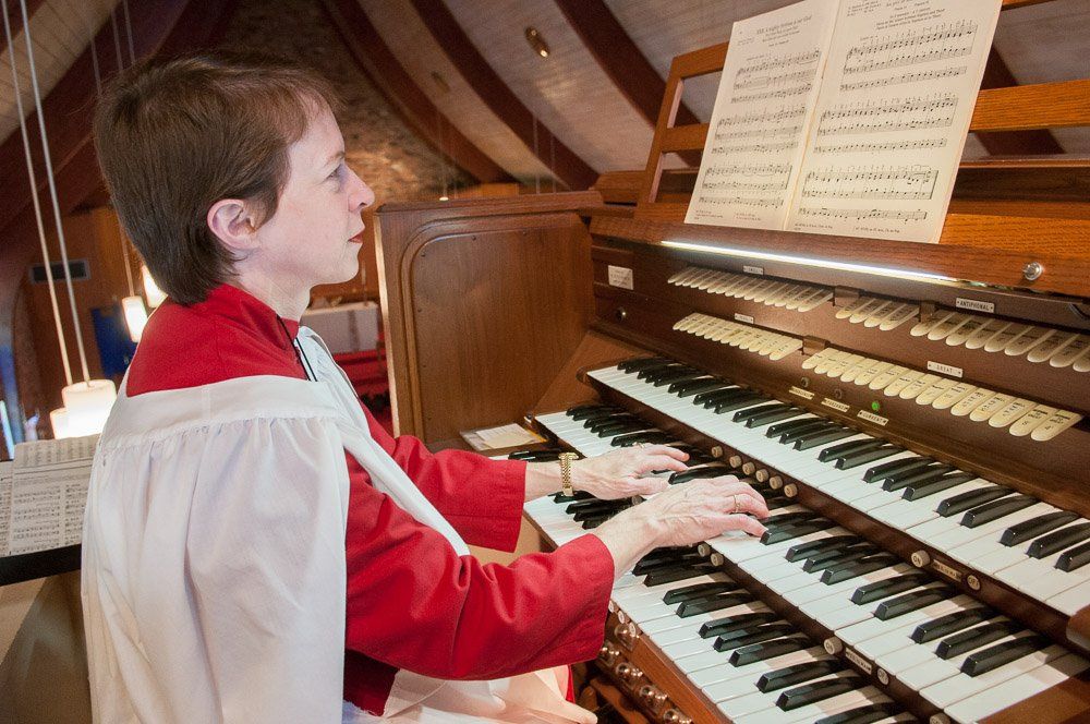 a woman is playing an organ in a church .