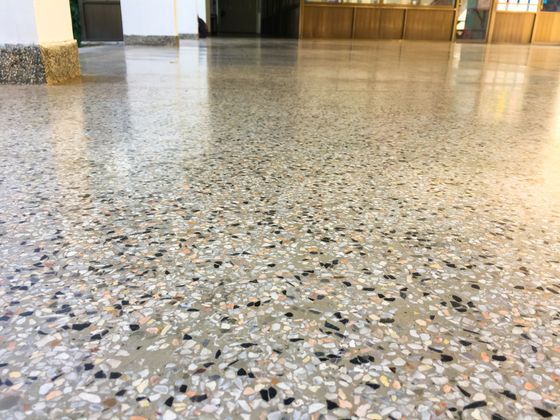 A concrete floor with a lot of small rocks on it