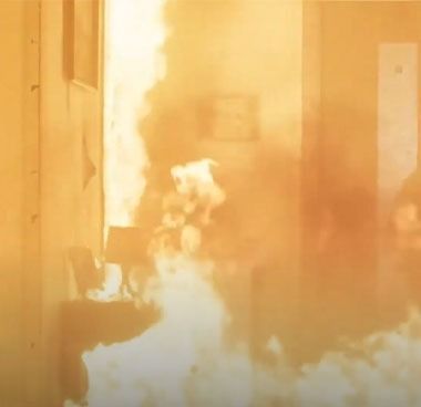 Interior room engulfed in flames and thick smoke.