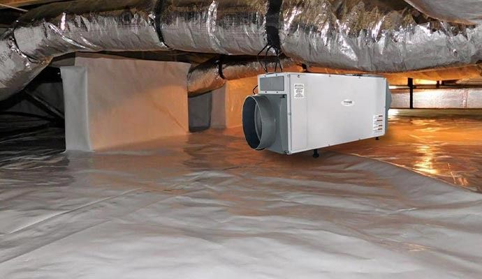 Crawlspace with white vapor barrier, HVAC unit, and ductwork.