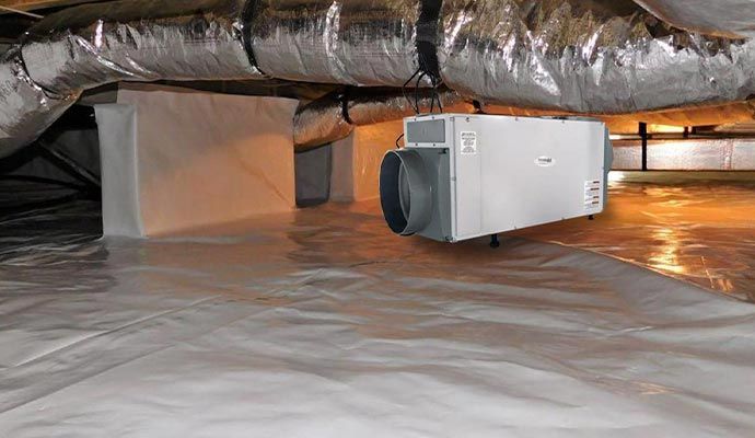 Crawlspace with white vapor barrier, HVAC unit, and ductwork.