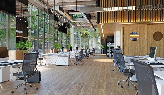 Modern office interior with workstations, natural light, and wooden accents.