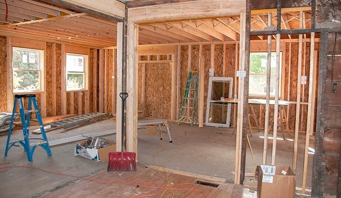 Interior of a building under construction, wooden framing visible.