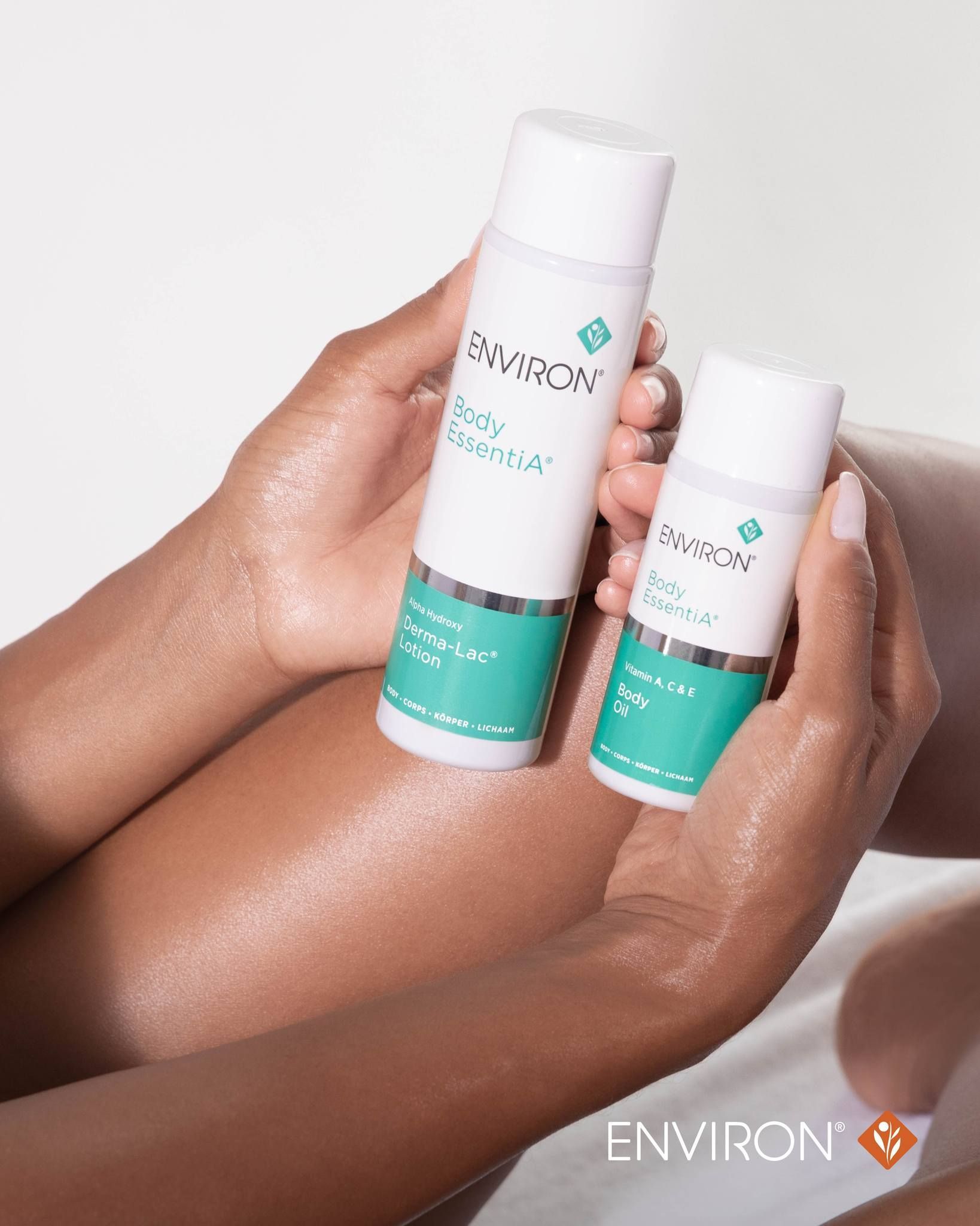 A woman is holding two bottles of lotion in her hands. — Skin Care Centre of Cairns In Cairns City, QLD