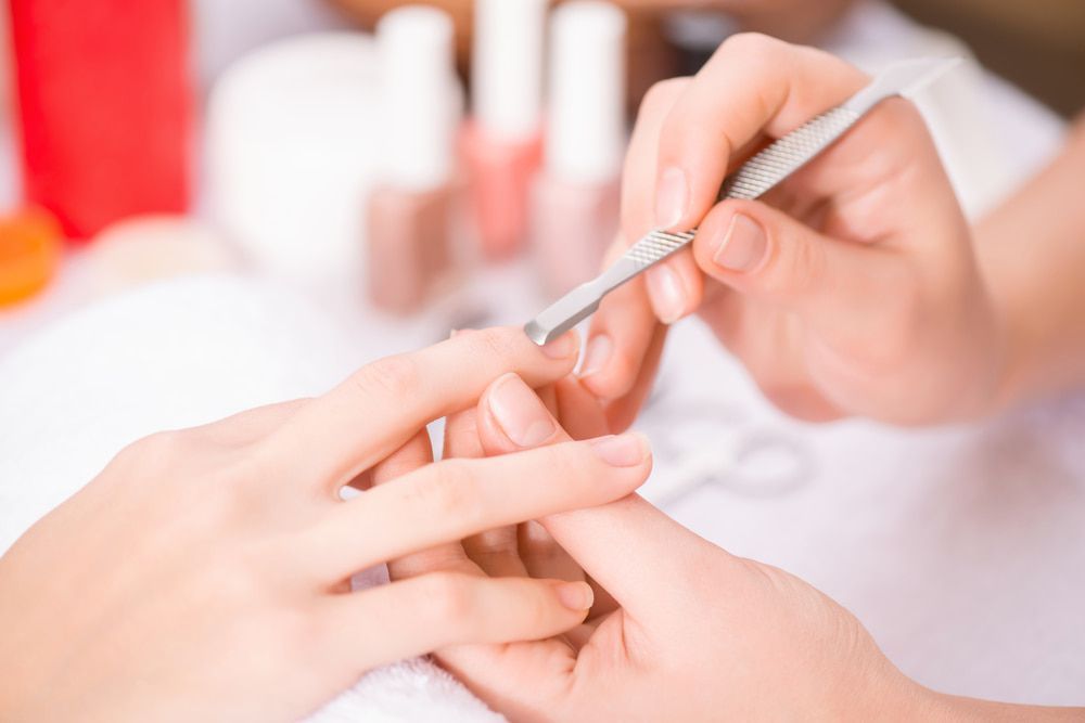 A Woman Is Getting Her Nails Done At A Nail Salon — Skin Care Centre of Cairns In Cairns City, QLD