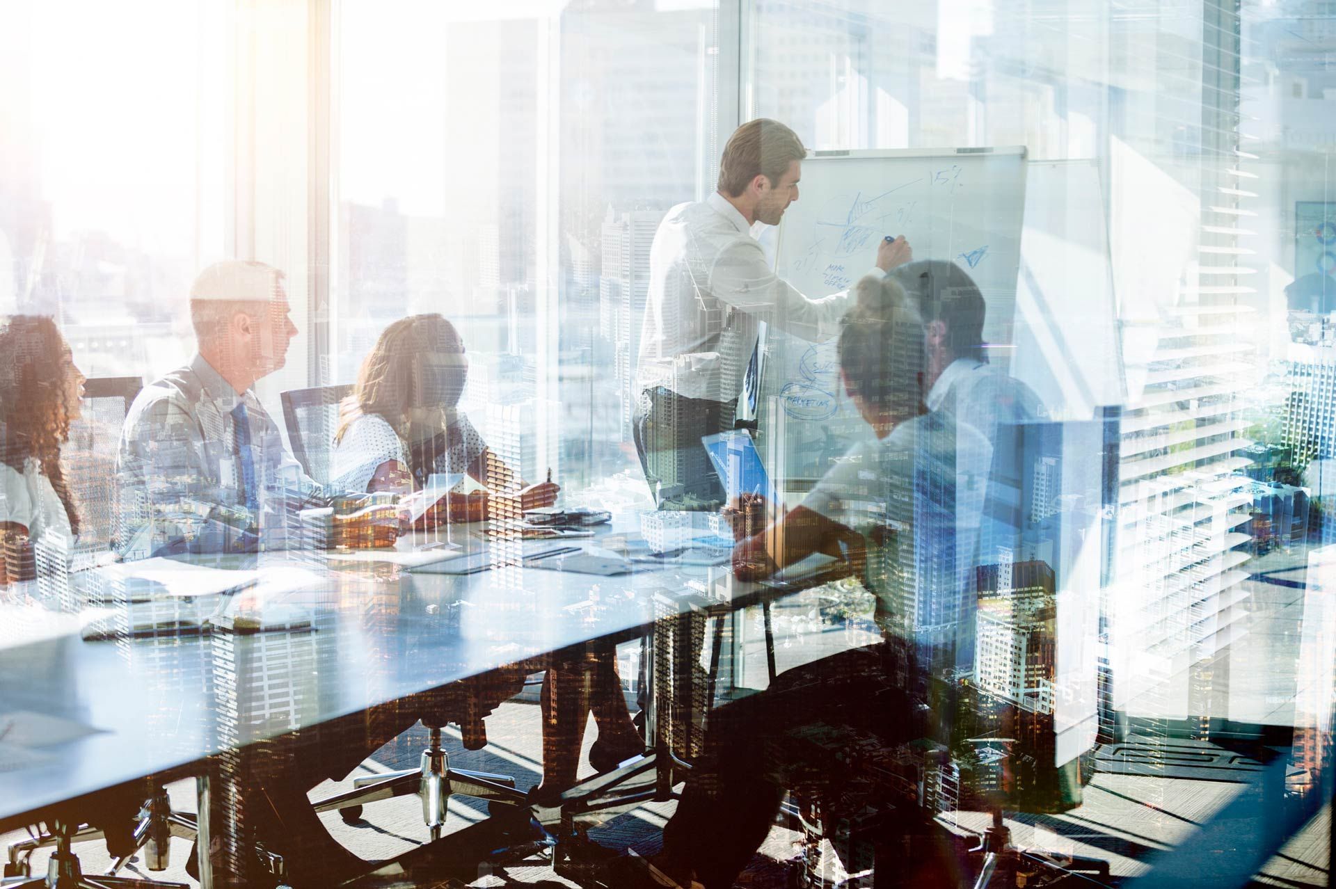 A group of business people are having a meeting in a conference room.