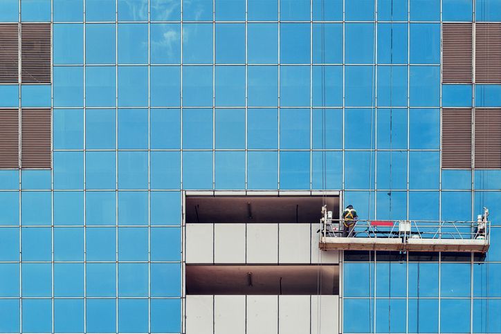 A white coffee cup on a wooden table with a blurred background.