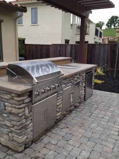 An outdoor kitchen with a grill and a sink | Landscape Design in Davis, CA