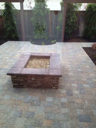 Beautifully designed paver patio and stone fire pit by Turfworks, Inc., a paver contractor in Vacaville, CA.