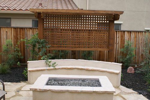 A landscape design in Davis, CA with a fire pit in the middle of the backyard.
