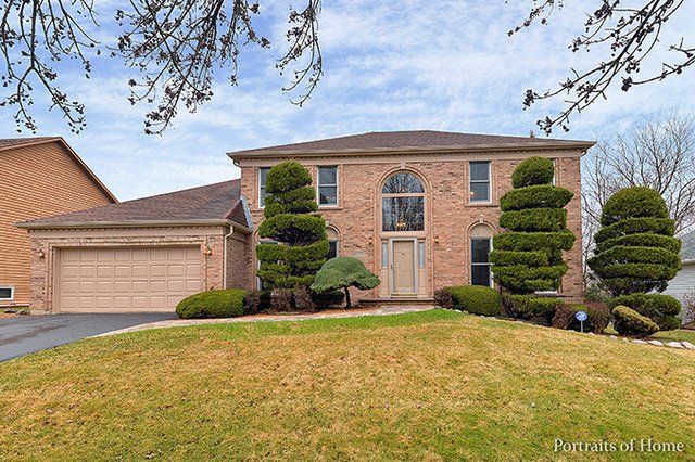 A large brick house with trees in front of it