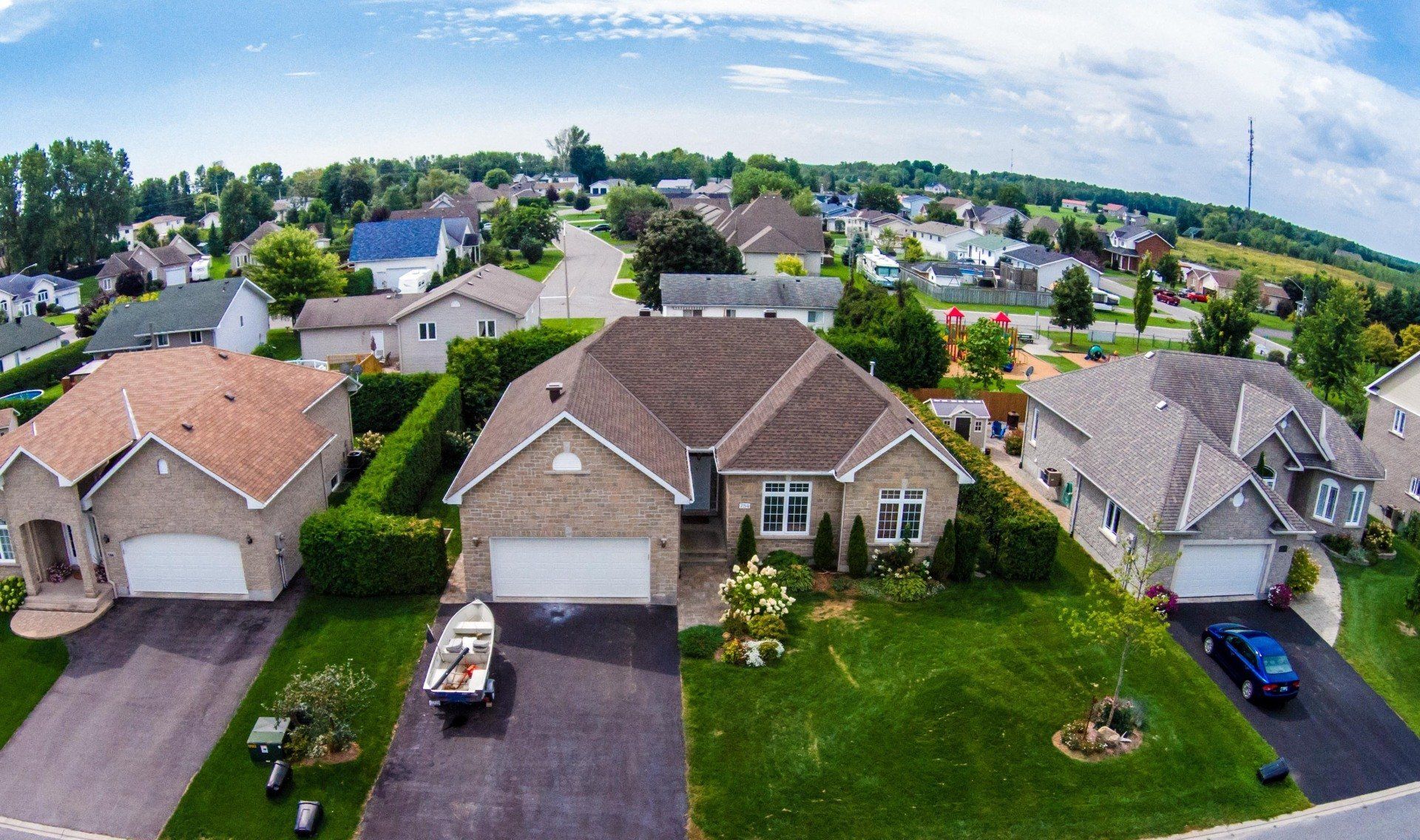 An aerial view of a residential area with houses and garages