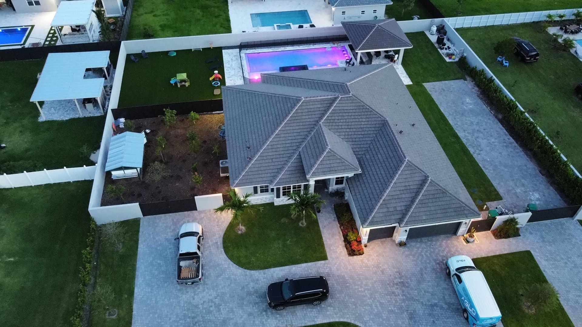 An aerial view of a house with a pool in the backyard