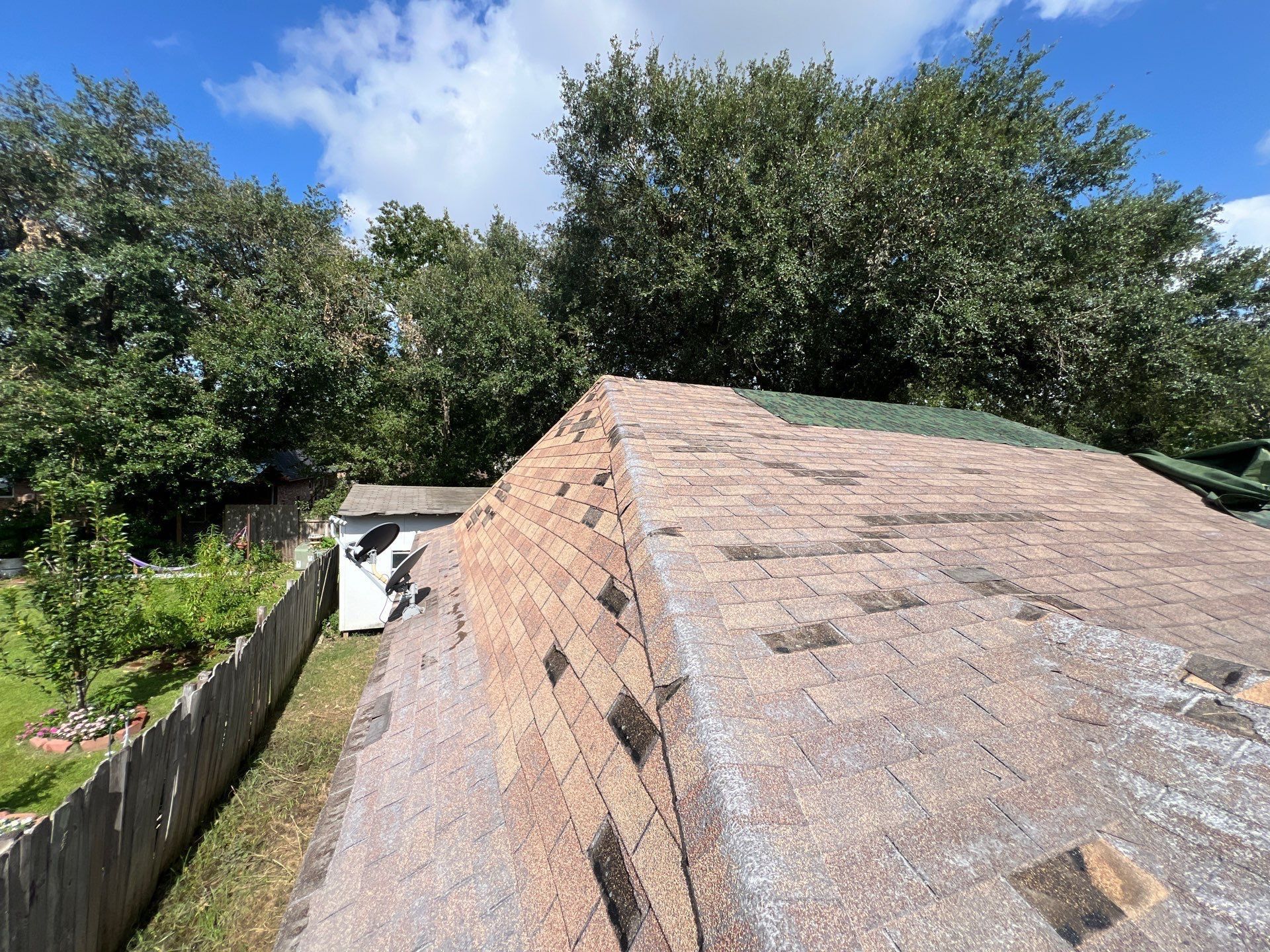 Wind Damaged roof in Conroe, Rizen Roofing did a full roof replacement.