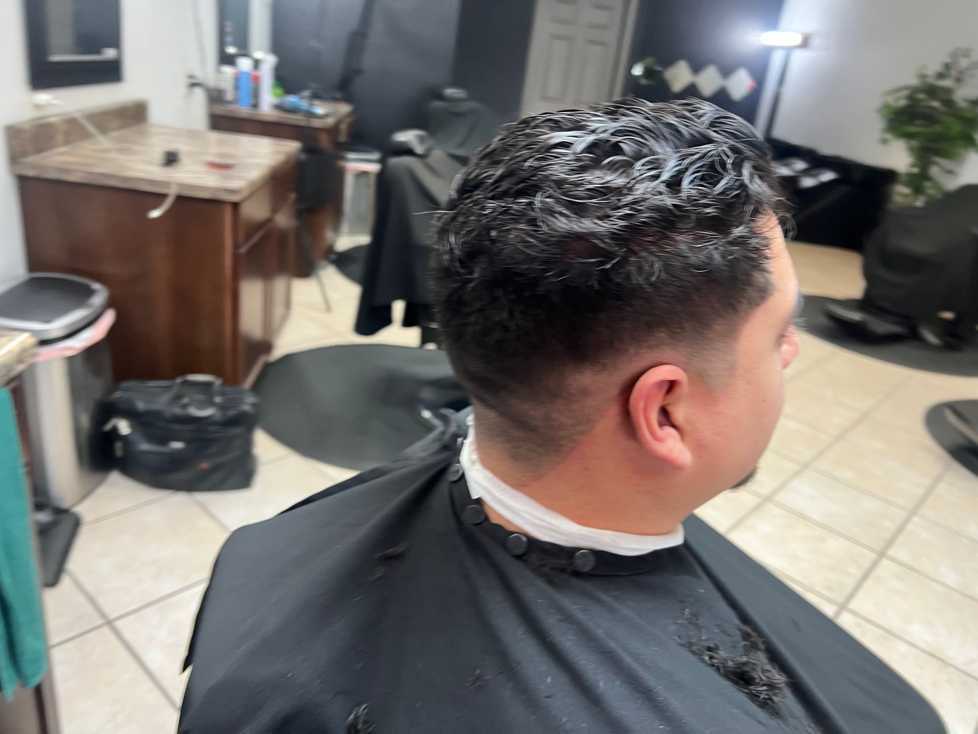 Man getting a haircut at the legendary right touch barbershop in Colorado Springs, CO.