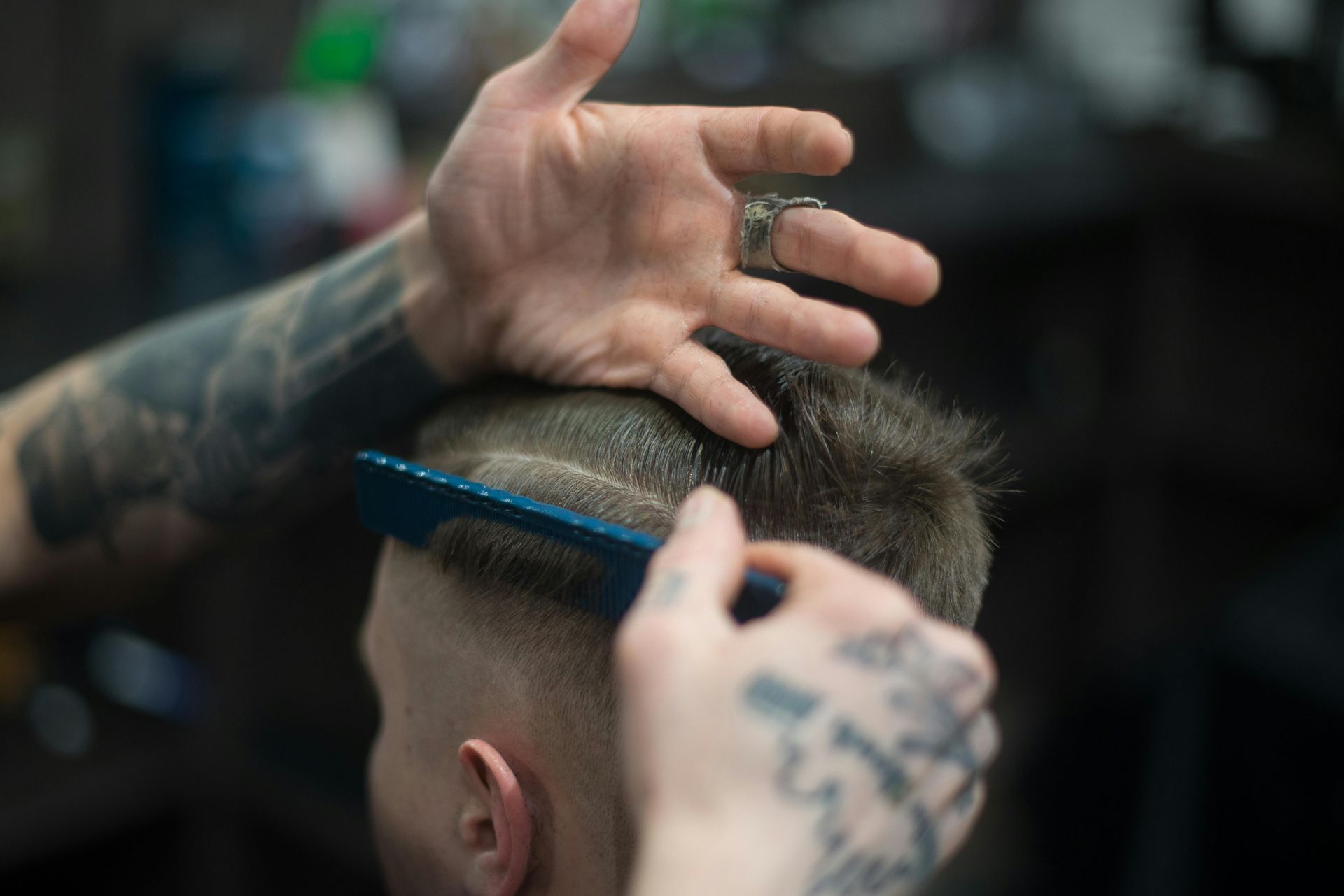 Barber prepping a design hair cut, precision mens haircut in colorado springs, CO.