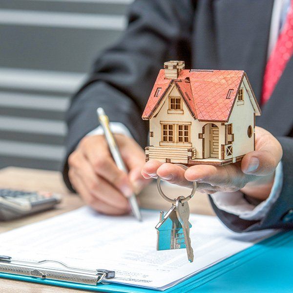 Lawyer Holding Key and House Model — Eugene, OR — Bromley Newton LLP