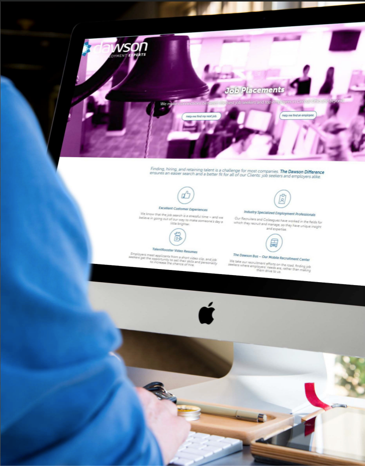 A person is sitting in front of an apple computer