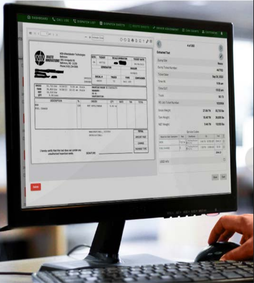 A person is typing on a keyboard in front of a computer monitor