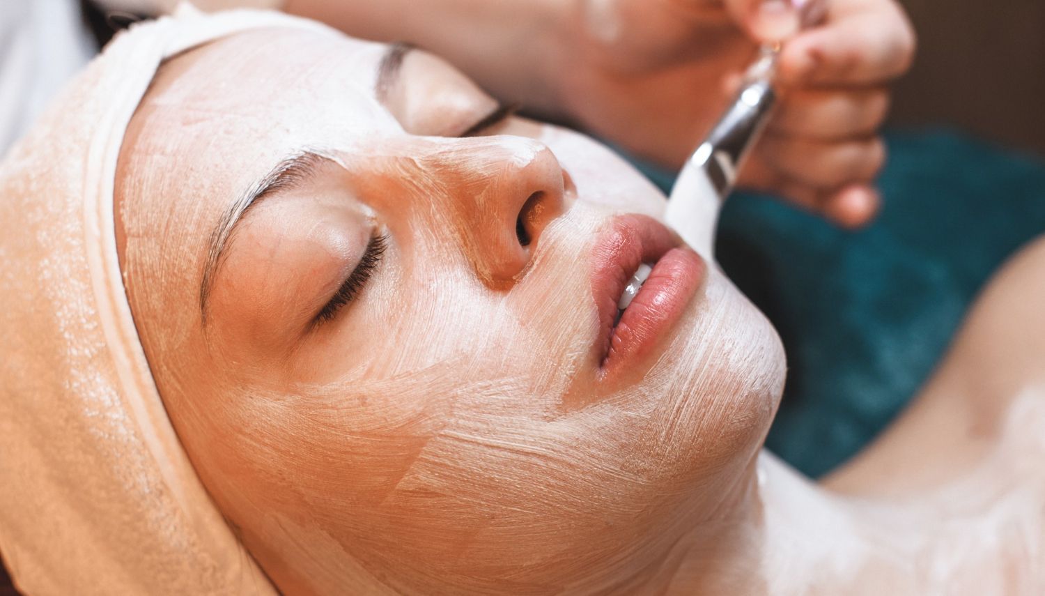 A woman is getting a facial treatment at a spa.