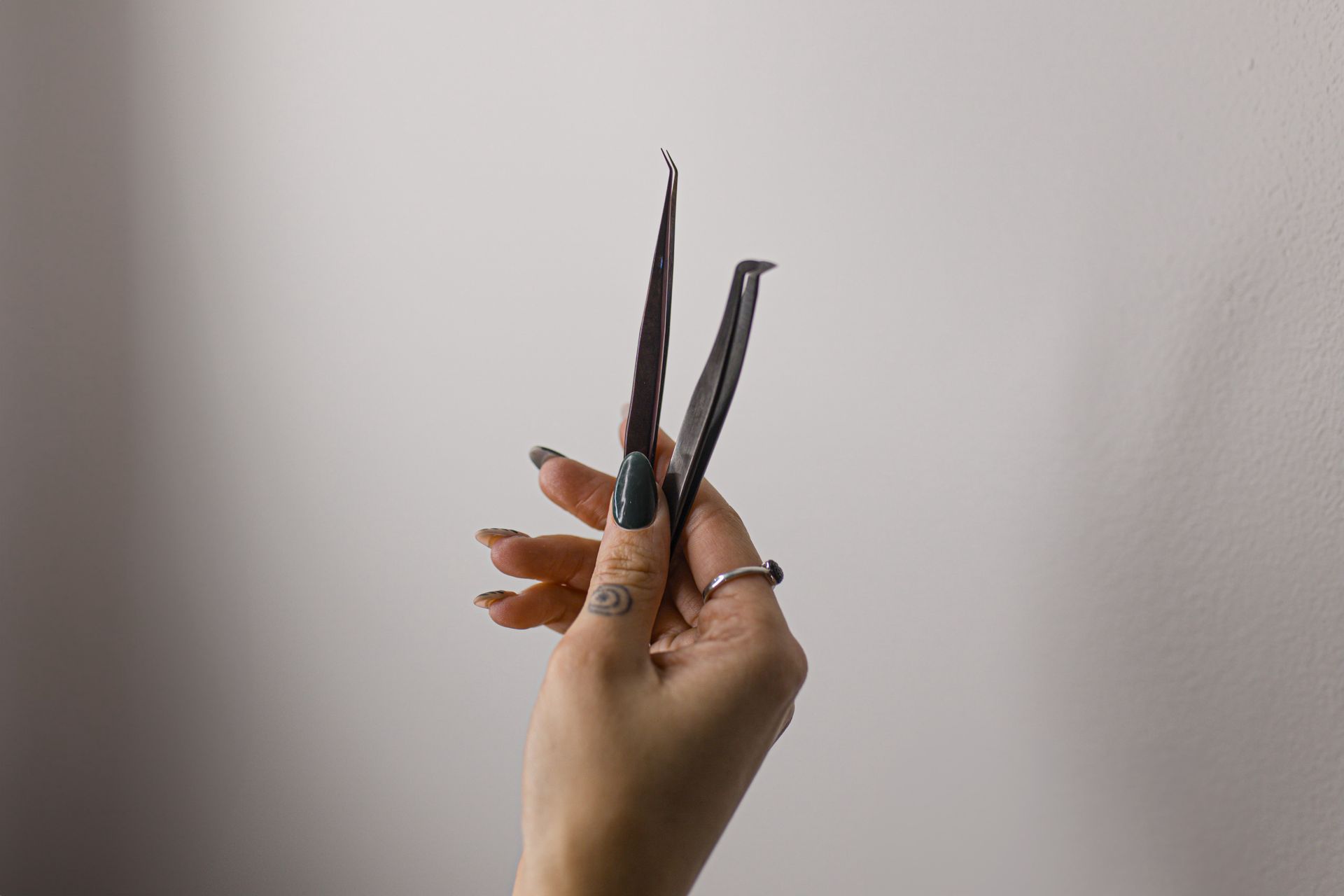 A woman is holding a pair of scissors in her hand.