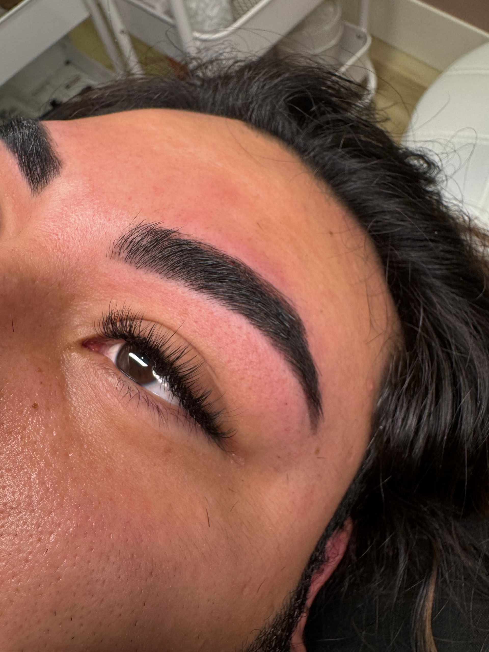 A close up of a man 's face with black eyebrows.