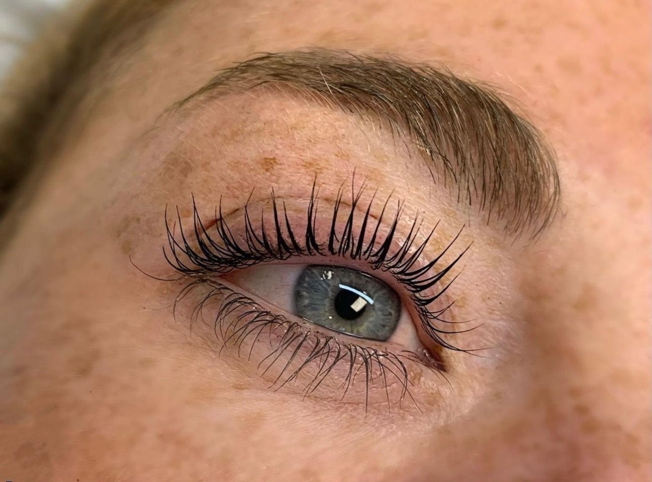 A close up of a woman 's eye with mascara on it.