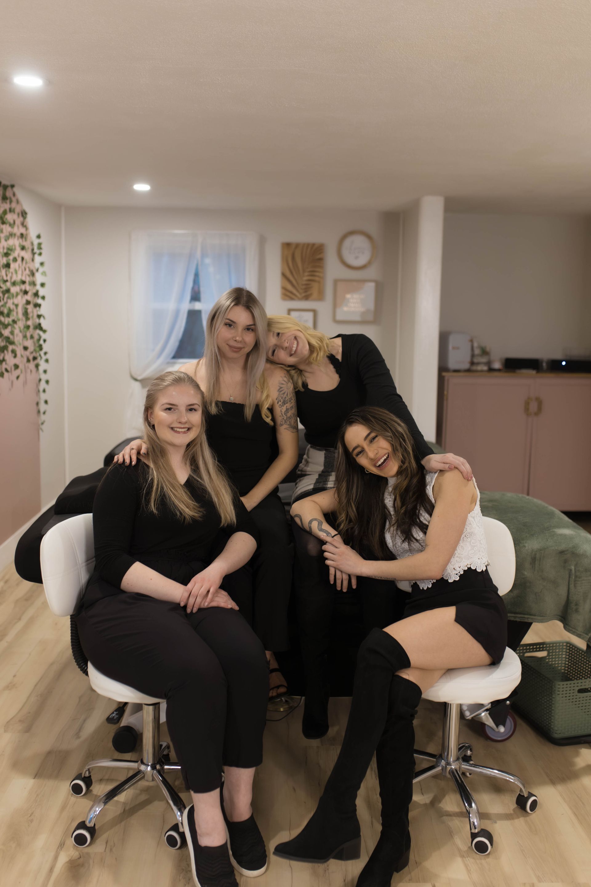 A group of women are posing for a picture while sitting on a couch.