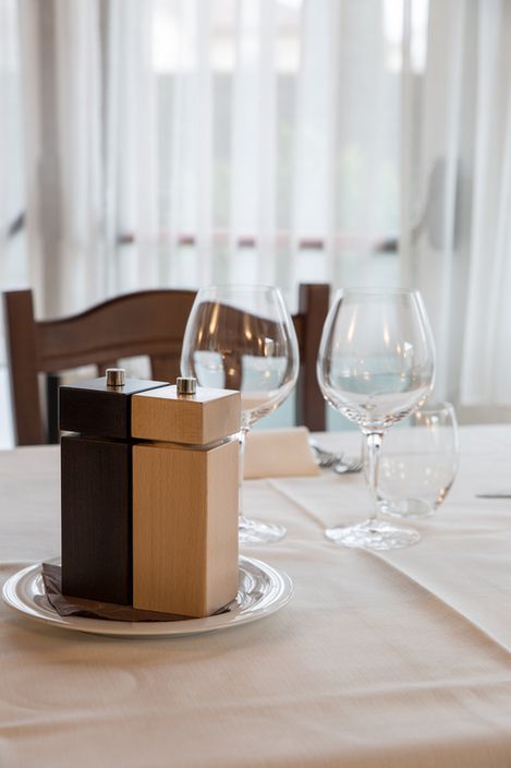 A salt and pepper shaker is sitting on a plate on a table.